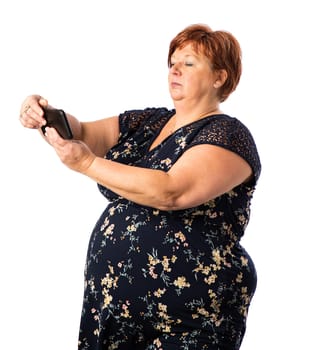 Fifty something woman holding a cellphone taking a selfie