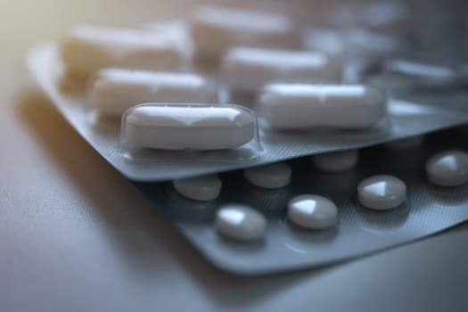 Closeup of pills in blister pack. Headache pills, painkillers, antibiotics or antidepressants tablets. High quality photo