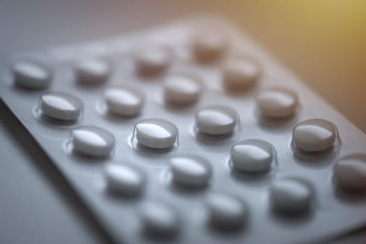 Closeup of pills in blister pack. Headache pills, painkillers, antibiotics or antidepressants tablets. High quality photo