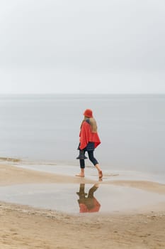 Swinoujscie , Poland – December 26, 2024: Fashionably dressed woman walking on the beach of Swinoujscie on the Polish Baltic Sea coast