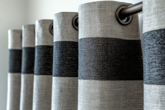 curtain rod holding gray curtains with grommets..