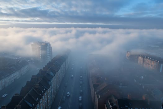 Thick fog envelops the city skyline, shrouding buildings and streets while creating a tranquil and mysterious early morning landscape.