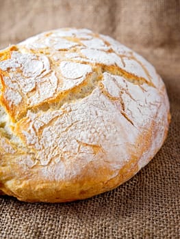 A close up photo of a round loaf of artisanal home baked bread.