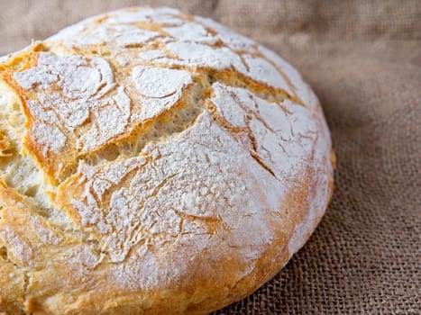 A close up photo of a round loaf of artisanal home baked bread.