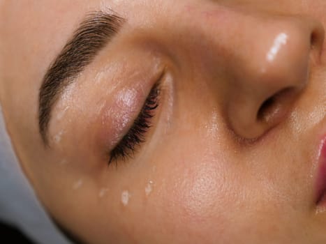 Anti-wrinkle moisturizing gel for the face around the eyes for the eyelids. Women's care at a beautician, close-up