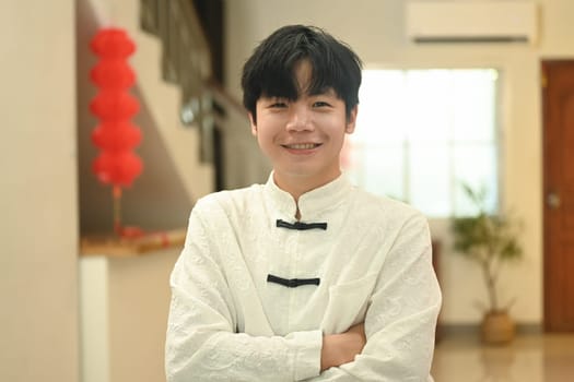 Portrait of a handsome young Chinese man dressed in elegant traditional clothing to celebrate a heritage festive.