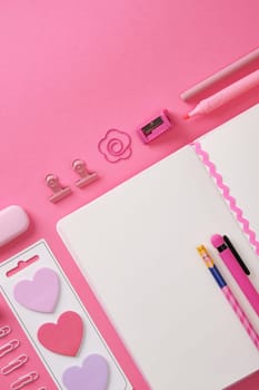 Pink stationery and an open notepad. Heart-shaped stickers. Space for your text.