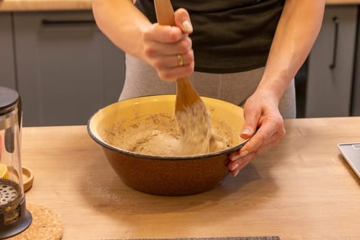 Woman kneads the dough in the bowl