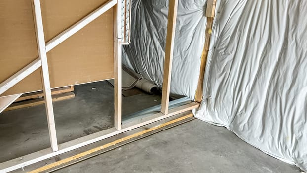 Castle Pines, Colorado USA - January 18, 2023-Close-up of an unfinished interior wall frame in a single-family house under construction in a suburban neighborhood. The photo showcases exposed studs and drywall, highlighting the early construction phase of the property.