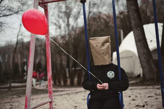 Photograph of a teen with a carton head mask . High quality photo