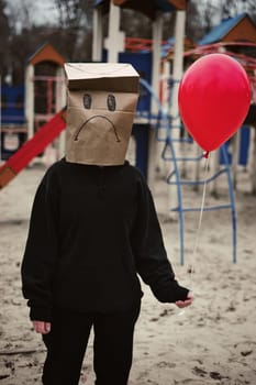 Photograph of a teen with a carton head mask . High quality photo