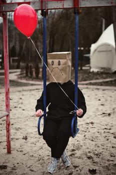 Photograph of a teen with a carton head mask . High quality photo