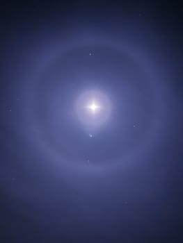 Double Moon Halo at the top of the mountain on the background of the starry sky.