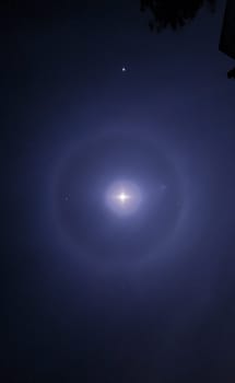Double Moon Halo at the top of the mountain on the background of the starry sky.