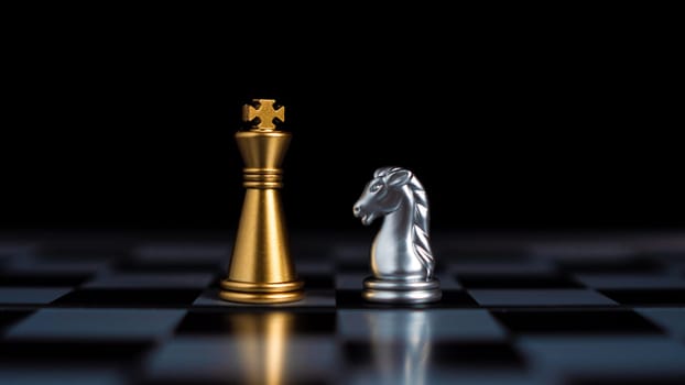 Gold and silver chess pieces in chess board game for business comparison. Leadership concepts, human resource management concepts.