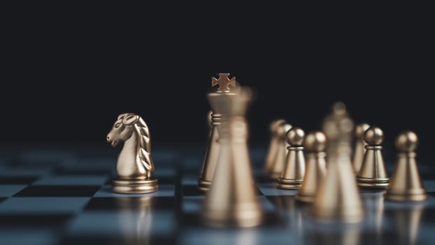 Gold and silver chess pieces in chess board game for business comparison. Leadership concepts, human resource management concepts.