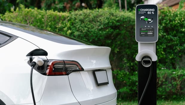 Electric vehicle technology utilized to residential home charging station for EV car battery recharge. Eco-friendly transport by clean and sustainable energy for future environment.Panorama Synchronos