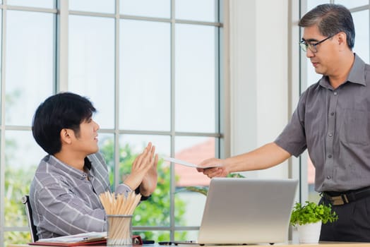 Asian businessman anti bribery and corruption he rejecting money in white envelope offered by partner. Business man sending resignation letter to employee the business downturn to laid off at office