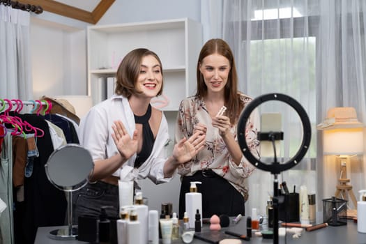 Woman influencer shoot live streaming vlog video review makeup utmost social media or blog. Happy young girl with cosmetics studio lighting for marketing recording session broadcasting online.