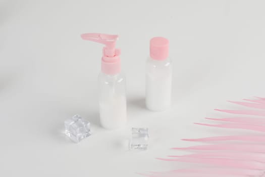 Beauty cosmetics glassbottle. branding mock up, front view on pastel pink and white background. Package for essential oil.