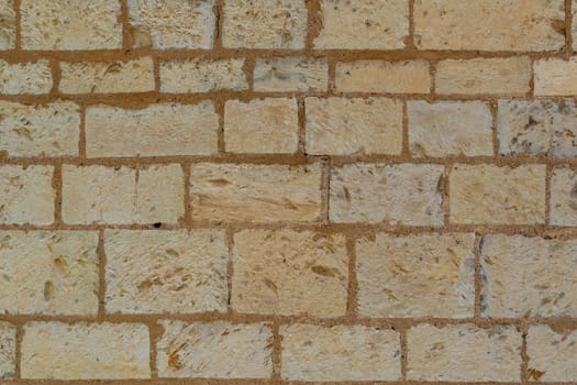 A surface of regular rectangular stone blocks. As a texture, background, background, for further graphic work