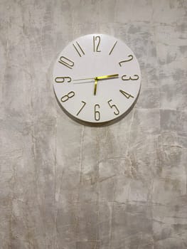 A stylish wall clock featuring bold numbers on a light textured background. Its clean design complements the modern decor, creating a serene and organized ambiance in any room.