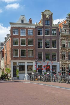 A lof of bicycles on the bridge in Amsterdam. (Netherlands). Vertically. All potential trademarks are removed.