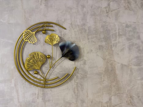 Decorative wall art showcases metallic ginkgo leaves with a blend of gold and blue tones. Perfect for adding a contemporary touch to any living space or office.