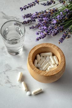 lavender pills and a glass of water. selective focus.