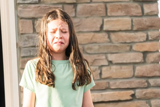 An unexpected dousing from a water mist leaves the little girl feeling a bit disheartened on a warm summer day.