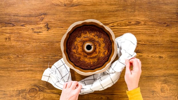 Flat lay. The gingerbread bundt cake cools gracefully on a wire rack, awaiting its sweet caramel frosting.
