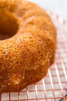 The freshly baked Carrot Bundt Cake is left to cool on the kitchen counter, filling the air with delightful aromas.