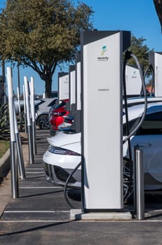 Georgetown, TX - 11 January 2025: Multiple electric cars connected to DC high speed charger at Electrify America public charging unit