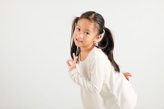 Exuberant young kid girl showcases the OK sign with an optimistic smile, conveying agreement and positivity isolated on a white background, ideal for your text customization. kindergarten child smile