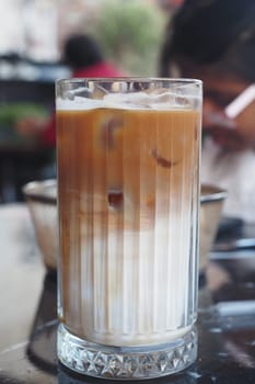 A beautiful top view of refreshing iced coffee filled with ice cubes, perfect for hot days