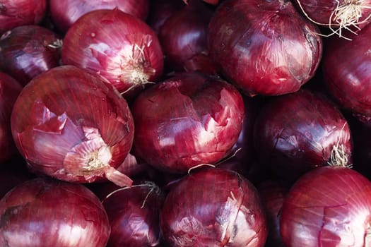 A vibrant and visually appealing display of fresh red onions, perfect for various culinary uses