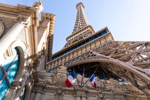 Eiffel Tower, Paris Las Vegas Hotel. Low Angle View. Blue Sunny Sky On Background. Tricolor Flag Of France And The USA. Copy Space, Horizontal Plane. Las Vegas, Nevada, USA: December, 27 2024.