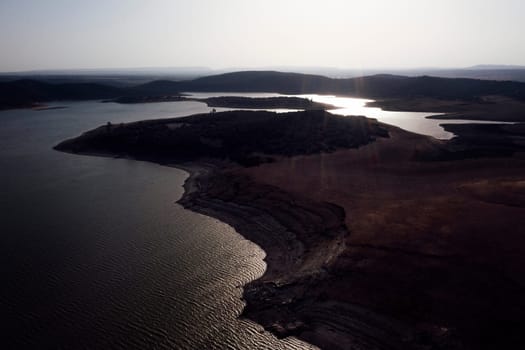 drone view of landscape with hills and lake with calm water, concept of peaceful and serene landscape in the vast expanse of land, copyspace for text