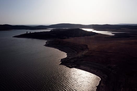 drone view of landscape with hills and lake with calm water, concept of peaceful and serene landscape in the vast expanse of land, copyspace for text