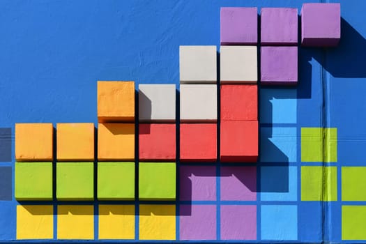 Colored squares on a blue wall Background