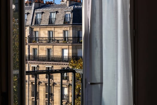Open window overlooking the city with old buildings. Paris, France