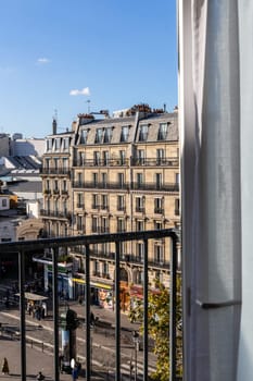 Open window overlooking the city with old buildings. Paris, France - October 24, 2024