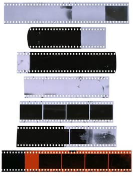 Old, used, dusty and scratched celluloid film strips isolated on white background