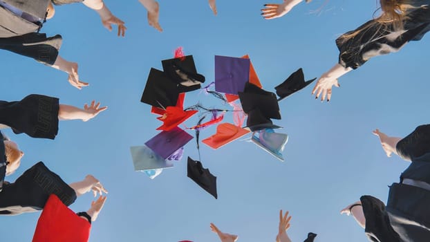 College graduates throw colorful hats up in the air