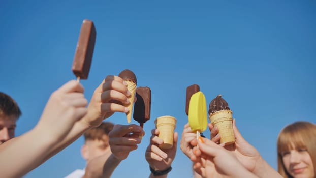 Friends link together colorful popsicles on a stick