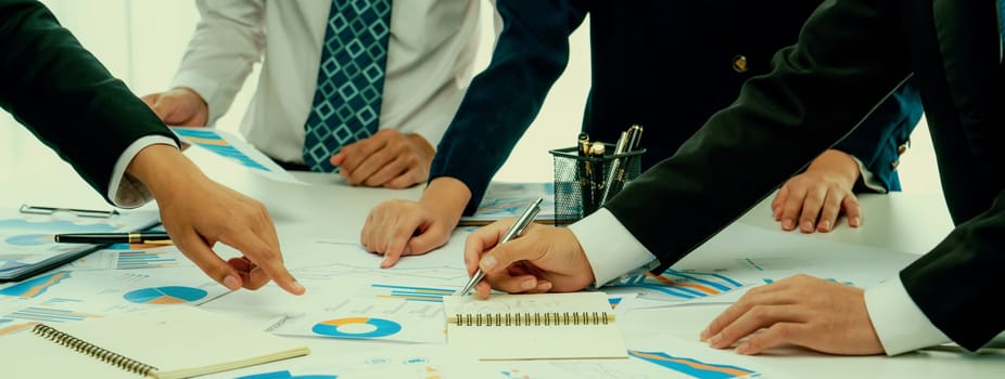 Business people in group meeting in formal attire share idea discussing report for company profit in creative workspace for start up business shot in close up view on group meeting table . Oratory .