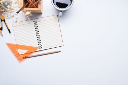 Workspace with coffee cup, notepad and pencil holder on white background. Copy space for text.