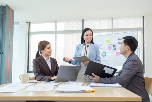 Business People Meeting using laptop computer,calculator,notebook,stock market chart paper for analysis Plans to improve quality next month. Conference Discussion Corporate Concept..