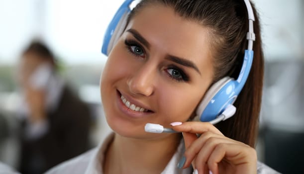 Beautiful brunette smiling call centre clerk at work portrait. Workplace employment effective mediation manager negotiation participation solve problem real time aid job concept