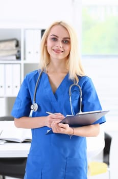 Beautiful smiling female doctor stand in office portrait. Physical and patient disease prevention exam er ward round 911 prescribe remedy healthy lifestyle consultant nurse profession concept